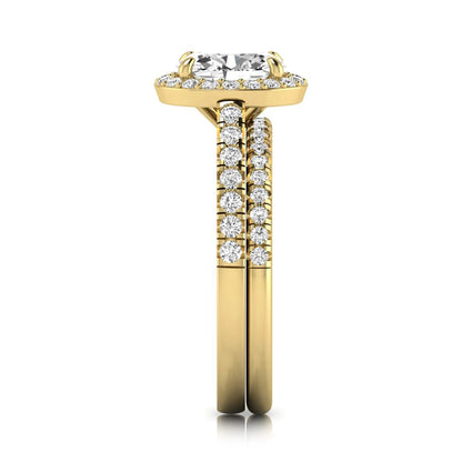 Oval halo lab grown diamond bridal ring set featuring an IGI certified oval cut center diamond with round pavé diamonds in a classic halo setting and matching wedding band in yellow gold