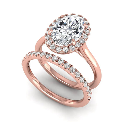 Oval halo lab grown diamond bridal ring set featuring a 2.00 carat oval center diamond with round halo and pavé side diamonds in rose gold finish.