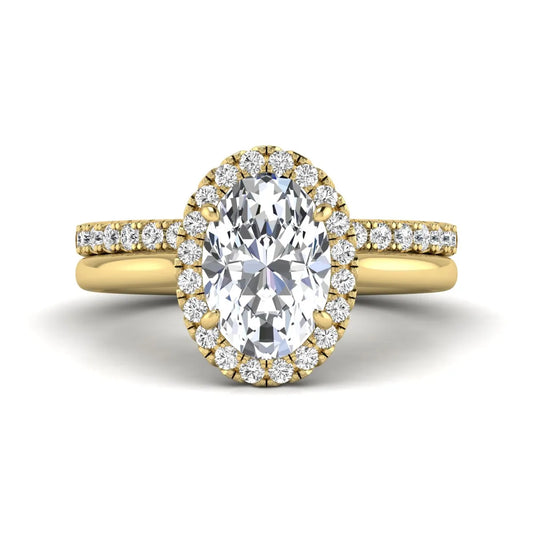 Oval halo lab grown diamond bridal ring set featuring a 2.00 carat oval center diamond with round halo and pavé side diamonds in yellow gold finish.