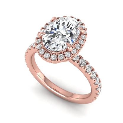 Oval cut lab grown diamond halo engagement ring with pavé round diamonds in a rose gold setting