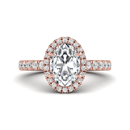 Oval cut lab grown diamond halo engagement ring with pavé round diamonds in a rose gold setting