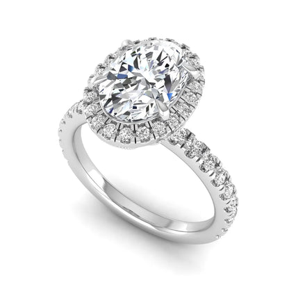 Oval cut lab grown diamond halo engagement ring with pavé round diamonds in a white gold setting