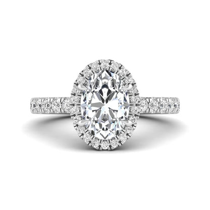 Oval cut lab grown diamond halo engagement ring with pavé round diamonds in a white gold setting