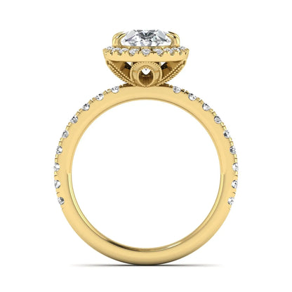 Oval cut lab grown diamond halo engagement ring with pavé round diamonds in a yellow gold setting
