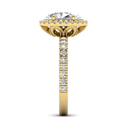 Oval cut lab grown diamond halo engagement ring with pavé round diamonds in a yellow gold setting