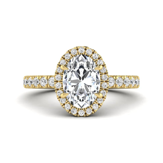 Oval cut lab grown diamond halo engagement ring with pavé round diamonds in a yellow gold setting