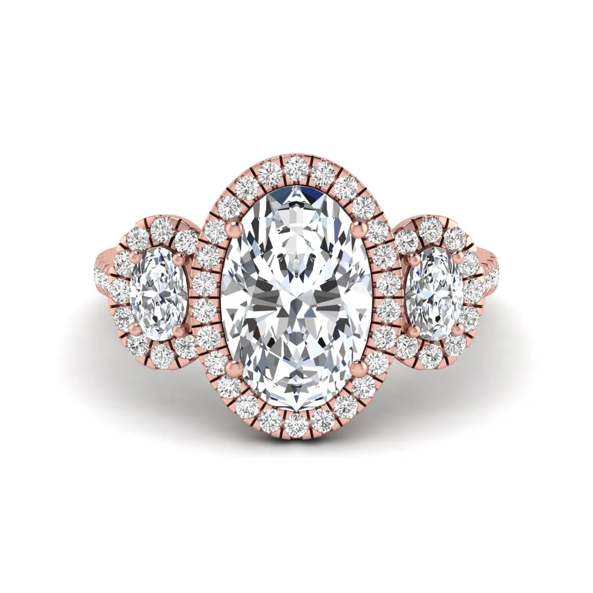 Oval cut lab grown diamond three stone engagement ring featuring a halo center, halo oval side diamonds, pavé shoulders, and a polished rose gold tone band.