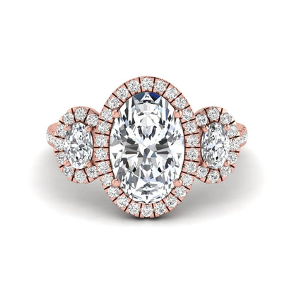 Oval cut lab grown diamond three stone engagement ring featuring a halo center, halo oval side diamonds, pavé shoulders, and a polished rose gold tone band.