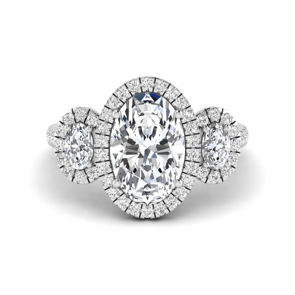 Oval cut lab grown diamond three stone engagement ring featuring a halo center, halo oval side diamonds, pavé shoulders, and a polished white gold tone band.