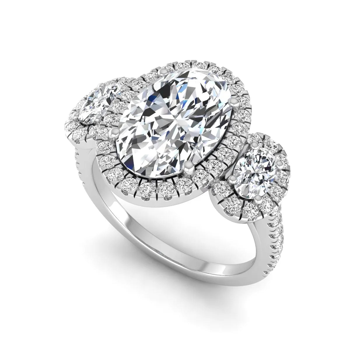 Oval cut lab grown diamond three stone engagement ring featuring a halo center, halo oval side diamonds, pavé shoulders, and a polished white gold tone band.