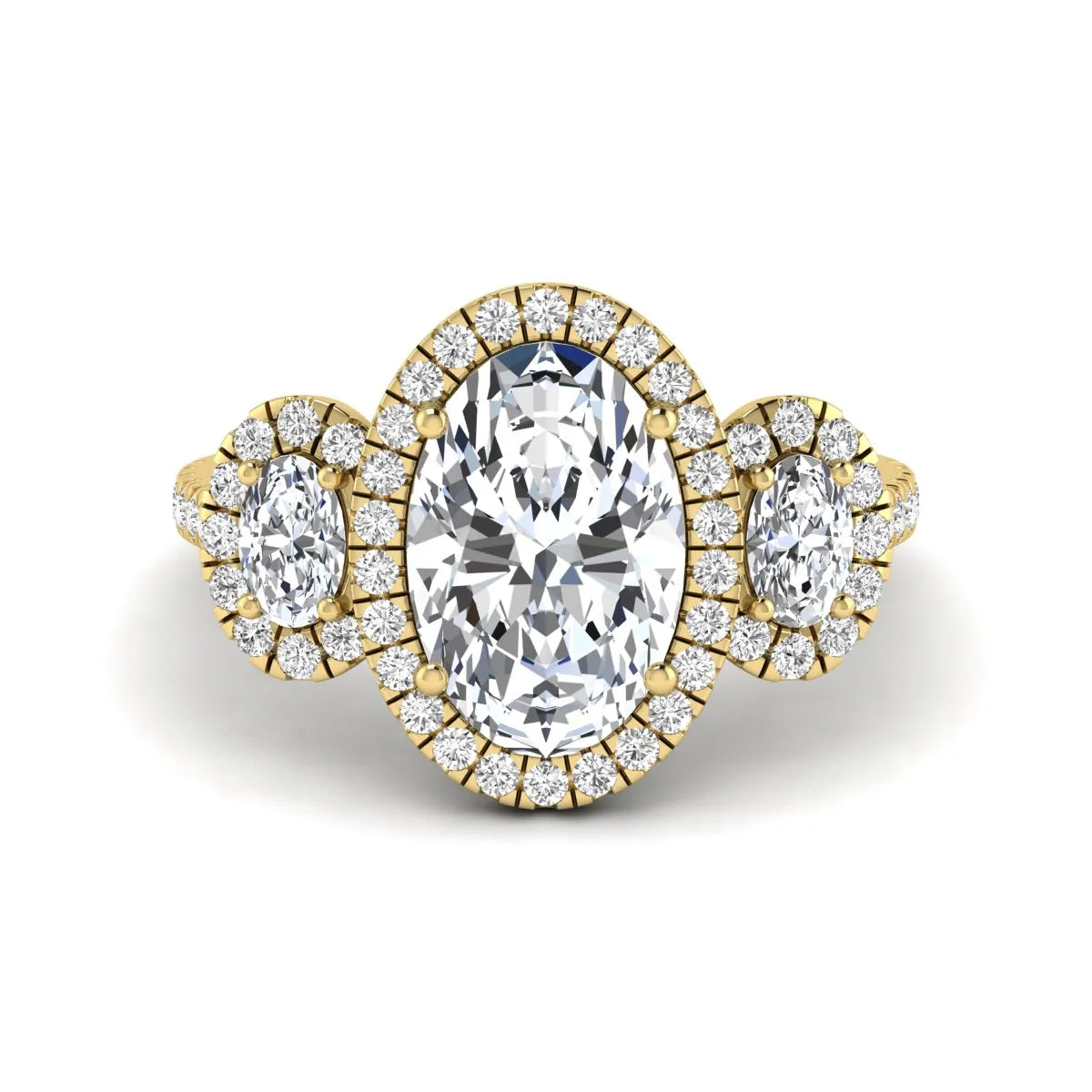 Oval cut lab grown diamond three stone engagement ring featuring a halo center, halo oval side diamonds, pavé shoulders, and a polished yellow gold tone band.