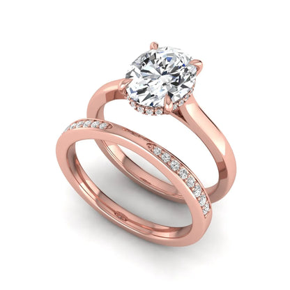 IGI Certified 2.54 carat oval cut lab grown diamond hidden halo bridal ring set with matching diamond wedding band in rose gold.
