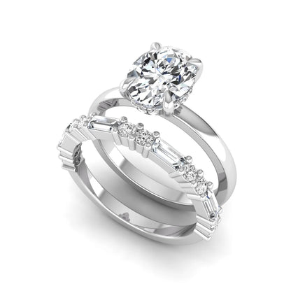 Oval cut lab grown diamond hidden halo bridal ring set featuring baguette and round side diamonds in white gold tone design.