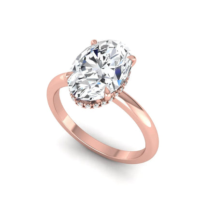 Oval cut hidden halo lab grown diamond engagement ring featuring a 2.99 carat IGI certified center diamond with round hidden halo accents in rose gold.