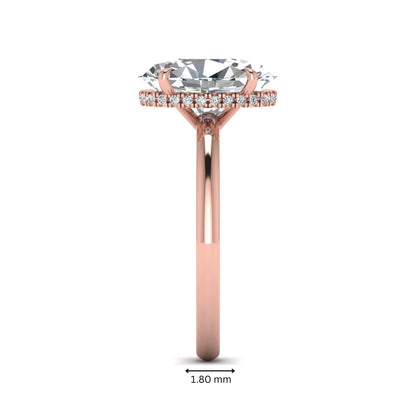 Oval cut hidden halo lab grown diamond engagement ring featuring a 2.99 carat IGI certified center diamond with round hidden halo accents in rose gold.