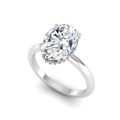 Oval cut hidden halo lab grown diamond engagement ring featuring a 2.99 carat IGI certified center diamond with round hidden halo accents in white gold.
