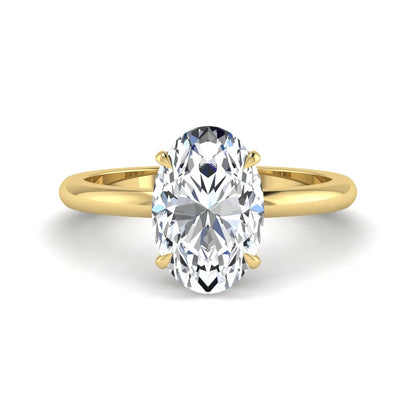 Oval cut hidden halo lab grown diamond engagement ring featuring a 2.99 carat IGI certified center diamond with round hidden halo accents in yellow gold.