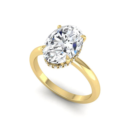 Oval cut hidden halo lab grown diamond engagement ring featuring a 2.99 carat IGI certified center diamond with round hidden halo accents in yellow gold.