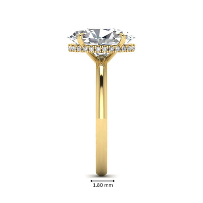 Oval cut hidden halo lab grown diamond engagement ring featuring a 2.99 carat IGI certified center diamond with round hidden halo accents in yellow gold.