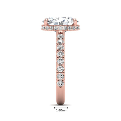 Oval cut lab grown diamond hidden halo engagement ring with pavé band and four-prong setting in a rose gold tone design.