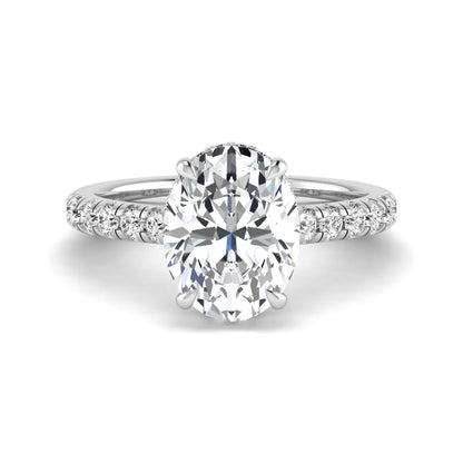 Oval cut lab grown diamond hidden halo engagement ring with pavé band and four-prong setting in a white gold tone design.