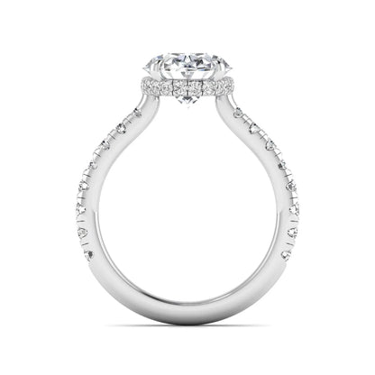 Oval cut lab grown diamond hidden halo engagement ring with pavé band and four-prong setting in a white gold tone design.