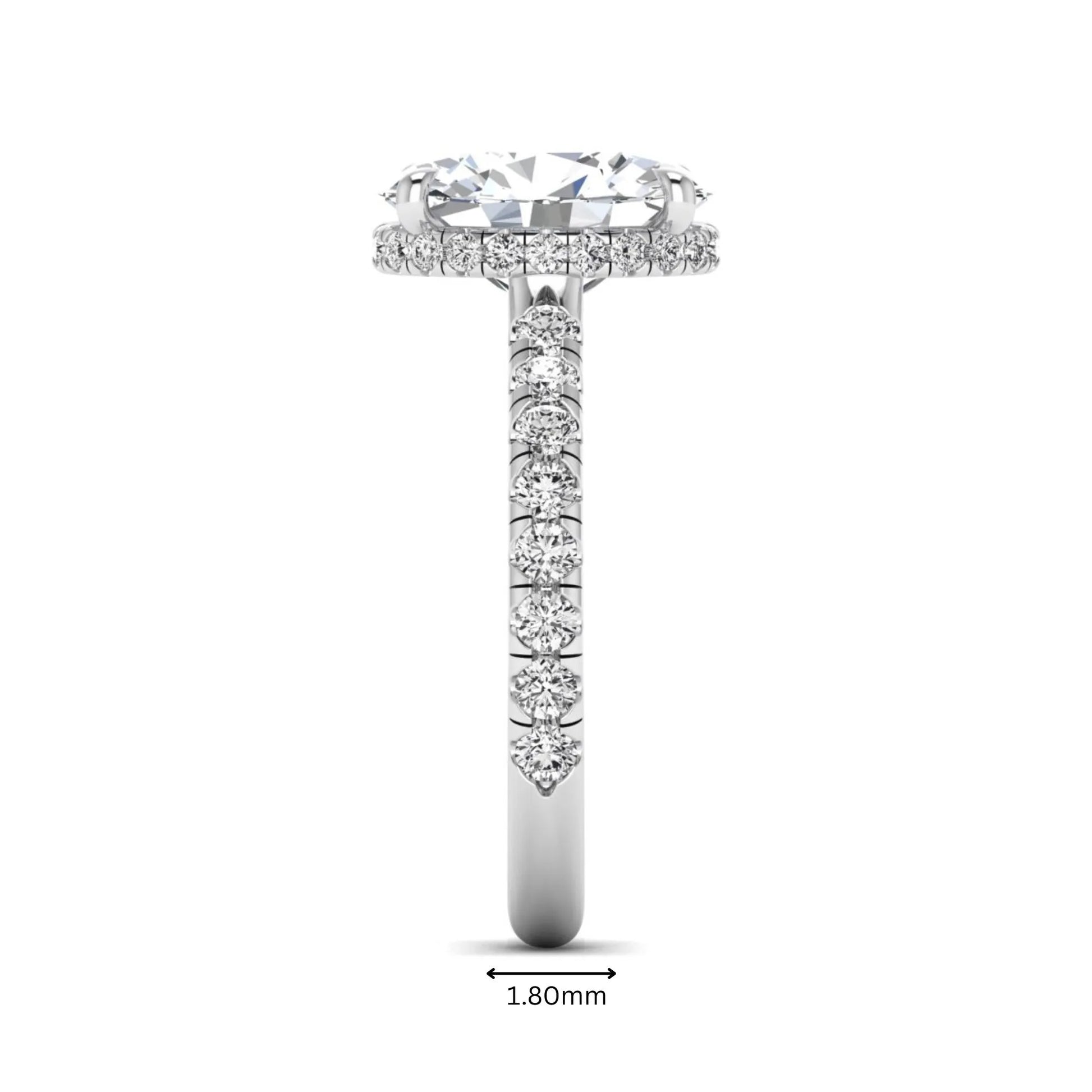 Oval cut lab grown diamond hidden halo engagement ring with pavé band and four-prong setting in a white gold tone design.