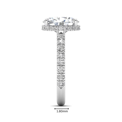 Oval cut lab grown diamond hidden halo engagement ring with pavé band and four-prong setting in a white gold tone design.