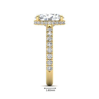 Oval cut lab grown diamond hidden halo engagement ring with pavé band and four-prong setting in a yellow gold tone design.
