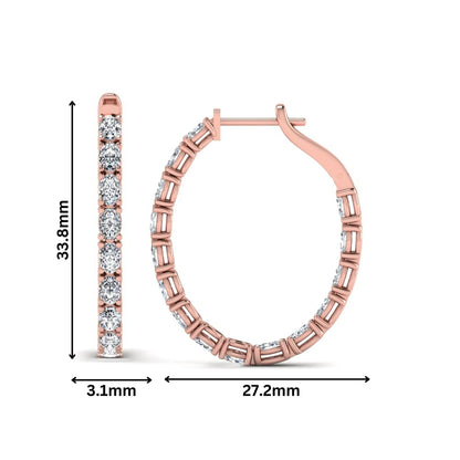 Oval cut lab grown diamond inside-out hoop earrings featuring shared prong settings, hinged snap closure, and rose gold tone design.