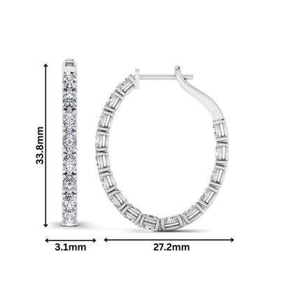 Oval cut lab grown diamond inside-out hoop earrings featuring shared prong settings, hinged snap closure, and white gold tone design.