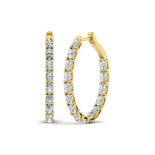 Oval cut lab grown diamond inside-out hoop earrings featuring shared prong settings, hinged snap closure, and yellow gold tone design.