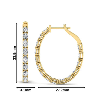 Oval cut lab grown diamond inside-out hoop earrings featuring shared prong settings, hinged snap closure, and yellow gold tone design.