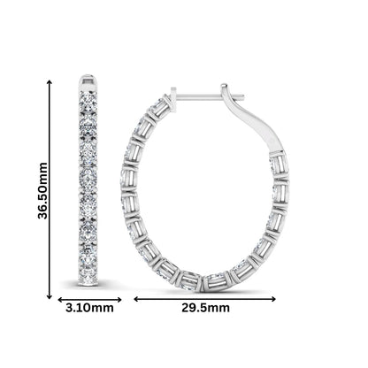 Oval cut lab grown diamond inside-out hoop earrings featuring shared prong settings, hinged snap closure, and white gold tone design.