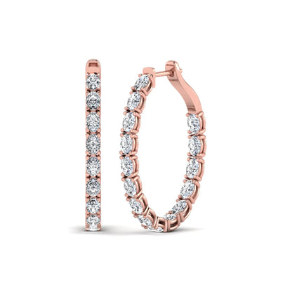 Oval cut lab grown diamond inside-out hoop earrings featuring shared prong settings, hinged snap closure, and rose gold tone design.