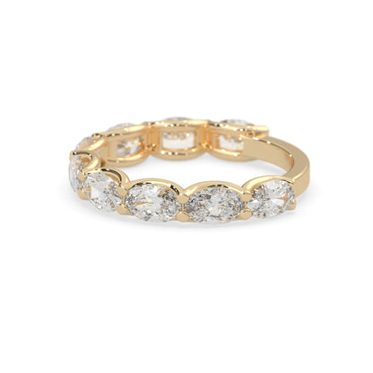 Oval lab grown diamond half eternity wedding band in a selected metal color with shared prong setting in yellow gold