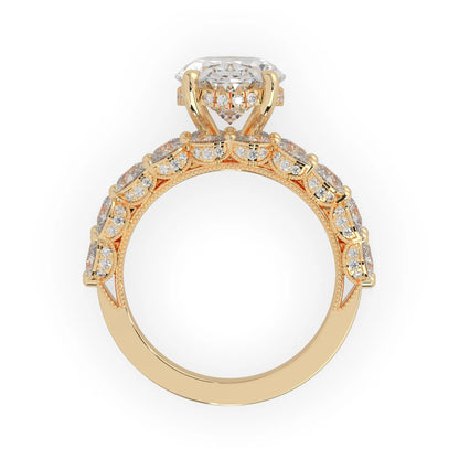 Oval lab grown diamond cocktail ring with emerald, round, and pear diamond accents in yellow gold