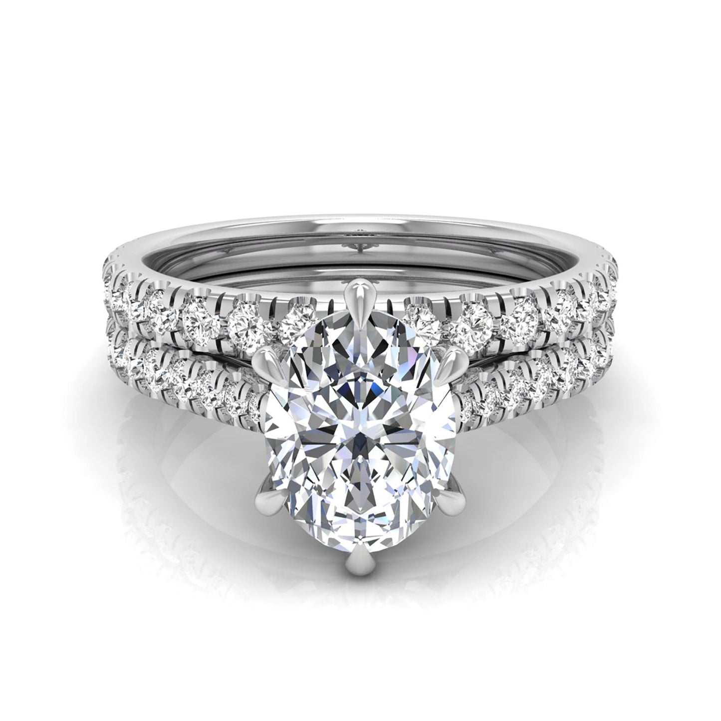 Oval cut lab grown diamond bridal ring set with pavé engagement ring and matching diamond wedding band in white gold style.