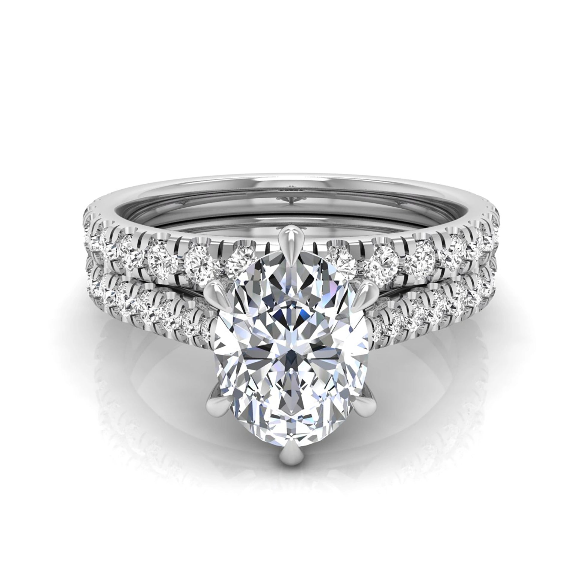 Oval cut lab grown diamond bridal ring set with pavé engagement ring and matching diamond wedding band in white gold style.