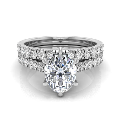Oval cut lab grown diamond bridal ring set with pavé engagement ring and matching diamond wedding band in white gold style.