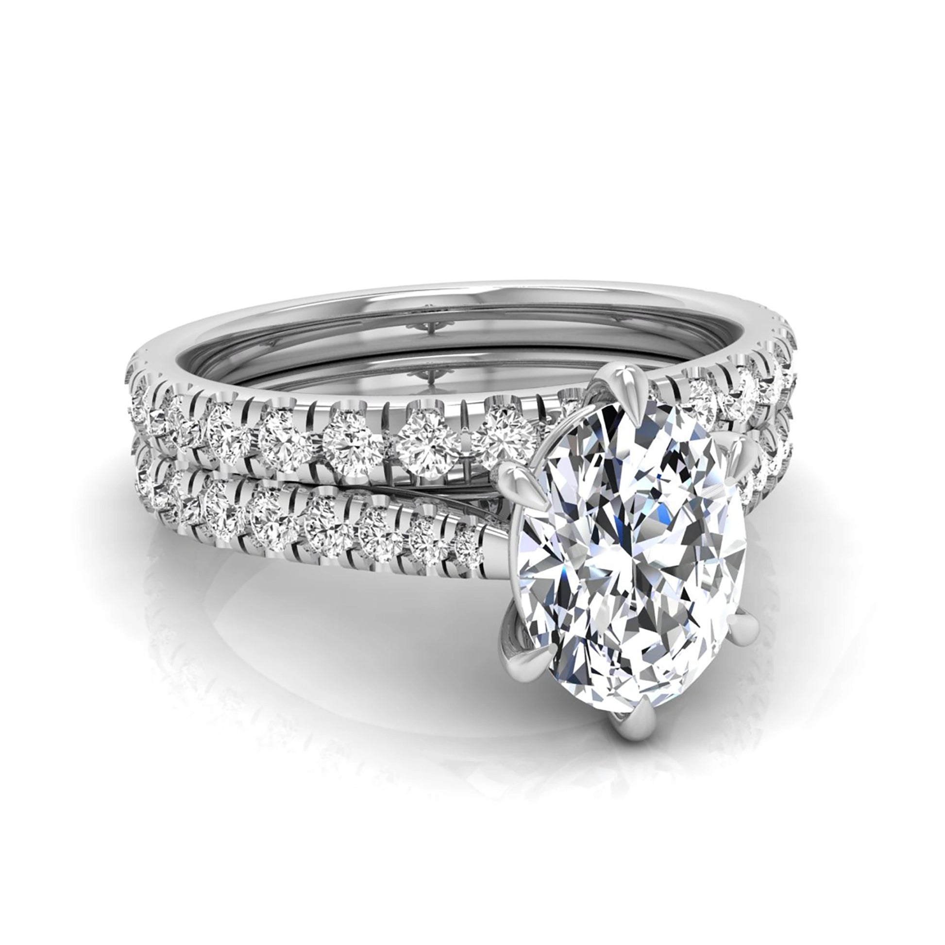 Oval cut lab grown diamond bridal ring set with pavé engagement ring and matching diamond wedding band in white gold style.