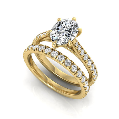 Oval cut lab grown diamond bridal ring set with pavé engagement ring and matching diamond wedding band in yellow gold style.