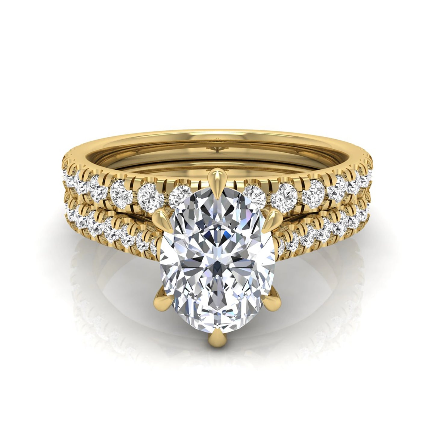 Oval cut lab grown diamond bridal ring set with pavé engagement ring and matching diamond wedding band in yellow gold style.