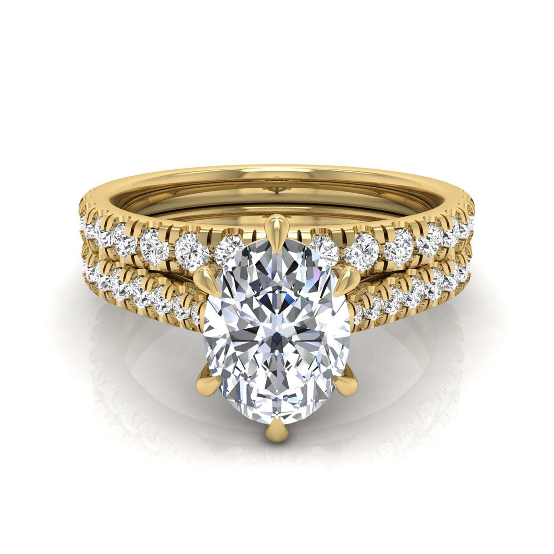 Oval cut lab grown diamond bridal ring set with pavé engagement ring and matching diamond wedding band in yellow gold style.