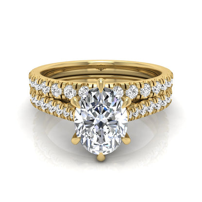 Oval cut lab grown diamond bridal ring set with pavé engagement ring and matching diamond wedding band in yellow gold style.