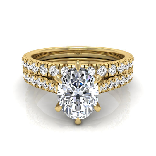 Oval cut lab grown diamond bridal ring set with pavé engagement ring and matching diamond wedding band in yellow gold style.