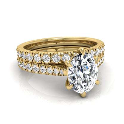 Oval cut lab grown diamond bridal ring set with pavé engagement ring and matching diamond wedding band in yellow gold style.