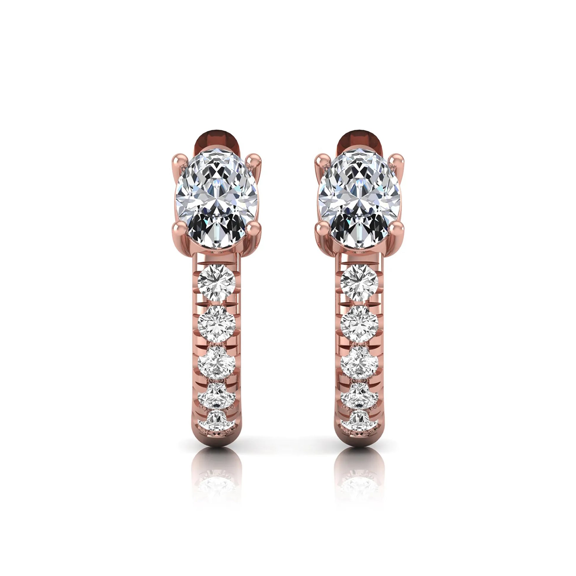Oval cut lab grown diamond huggie hoop earrings featuring a four prong basket set center diamond with graduated round brilliant pavé diamonds on a rose gold hoop.