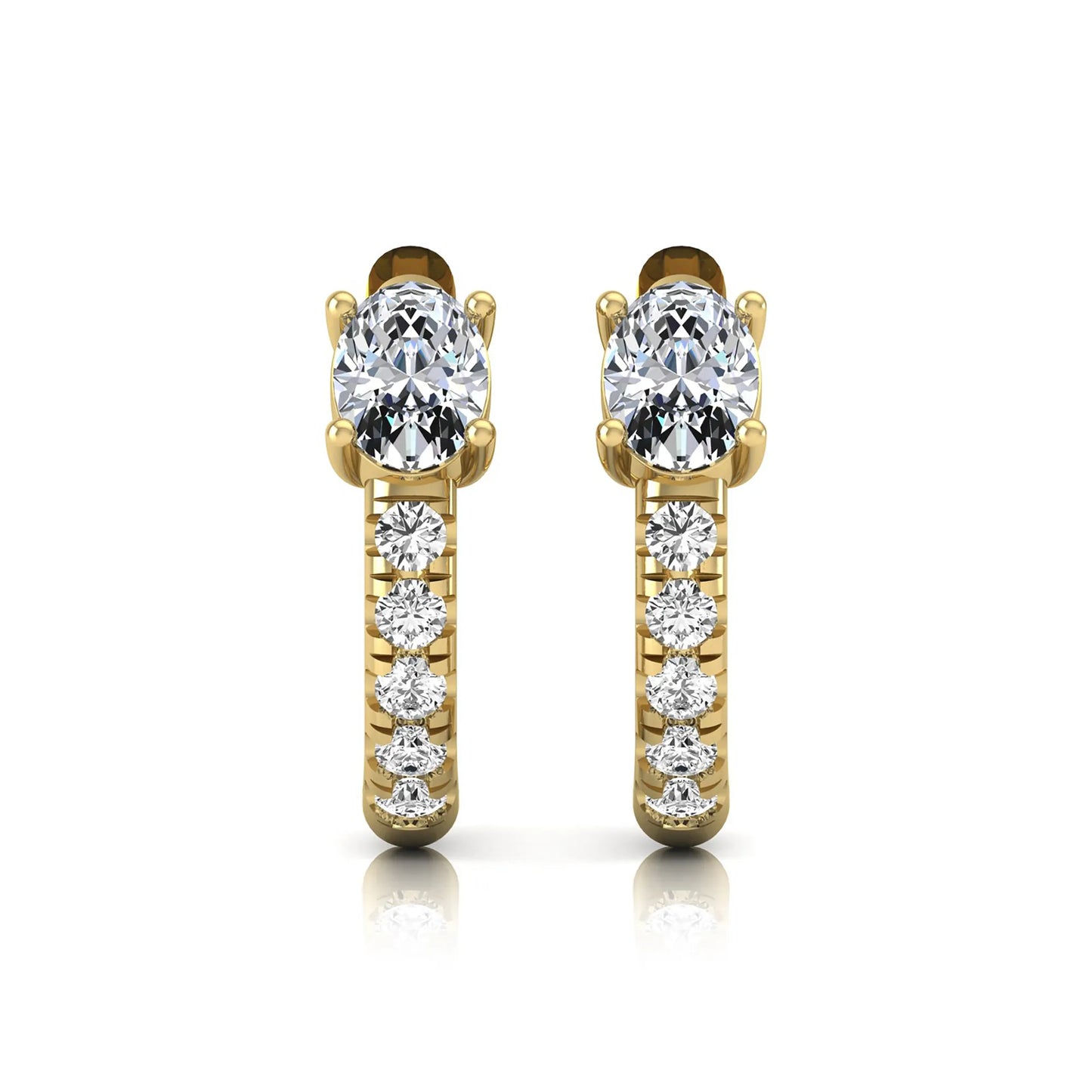 Oval cut lab grown diamond huggie hoop earrings featuring a four prong basket set center diamond with graduated round brilliant pavé diamonds on a yellow gold hoop.