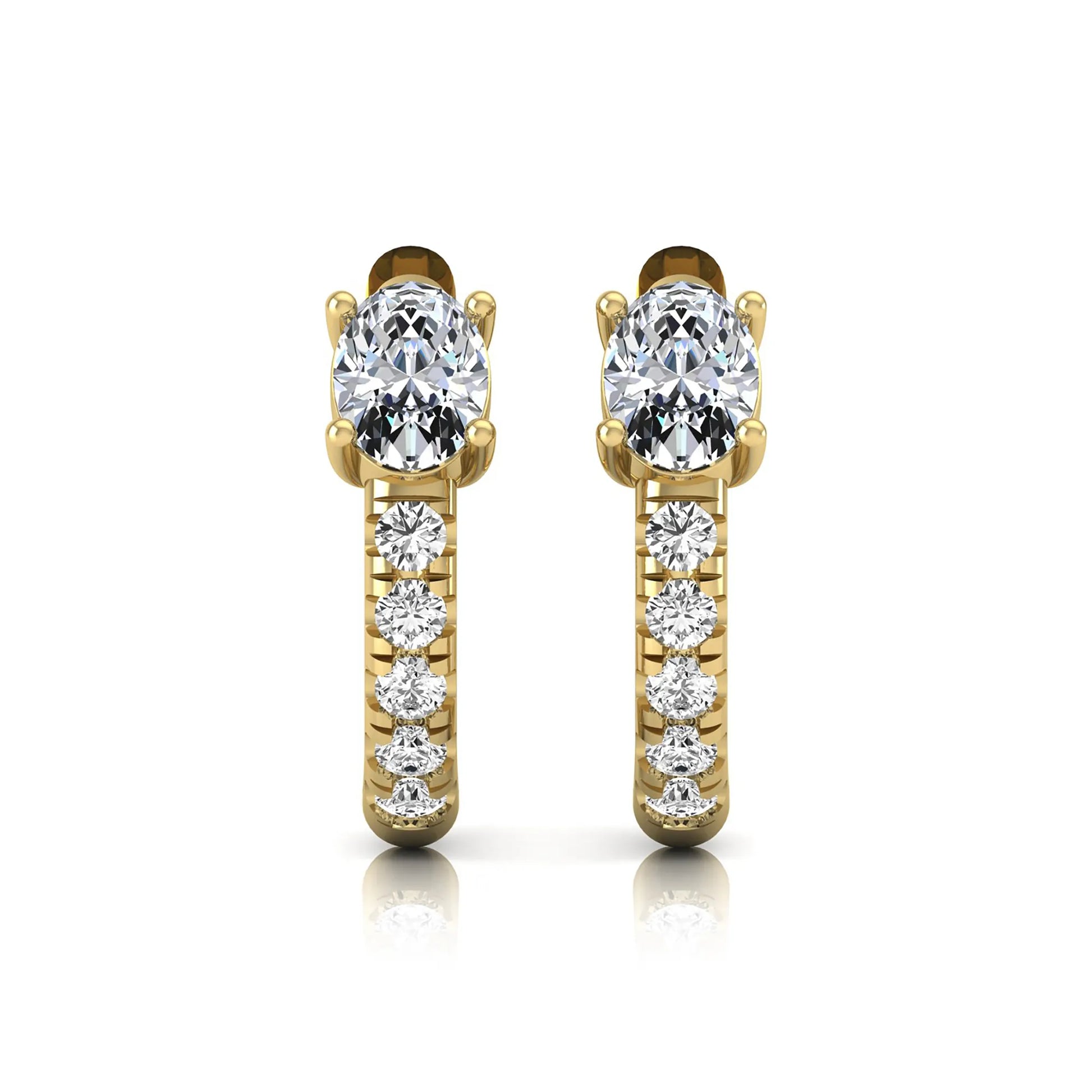 Oval cut lab grown diamond huggie hoop earrings featuring a four prong basket set center diamond with graduated round brilliant pavé diamonds on a yellow gold hoop.